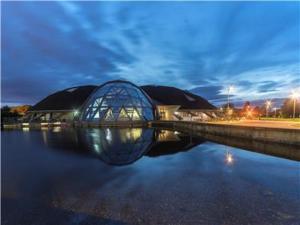 a building with a glass dome on a body of water at Lower Ashby Apartments in Scunthorpe