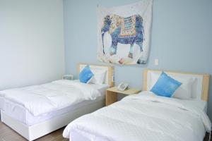 Postel nebo postele na pokoji v ubytování Golden W Hotel