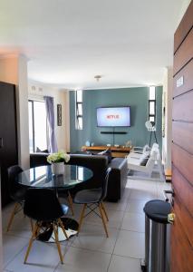 a living room with a couch and a table at 2Bedroom apartment in a secure golf estate.WIFI in Roodepoort