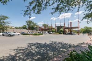 a parking lot with cars parked in a parking lot at 2Bedroom apartment in a secure golf estate.WIFI in Roodepoort