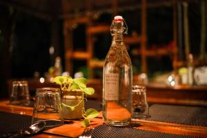 a bottle of alcohol sitting on top of a table at Golden Fern Resort in Kanthalloor +54 photos