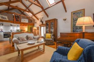 a living room with a couch and a piano at Townend Barn in Lydford