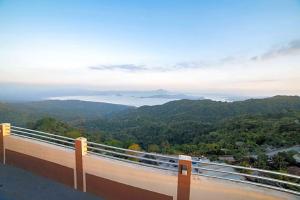 a balcony with a view of the mountains and water at Cityland Janna's Family Suite Full Taal Lake View & Studio Partial Taal Lake View or City View Free Pool, Parking, Wifi, and View Deck in Tagaytay