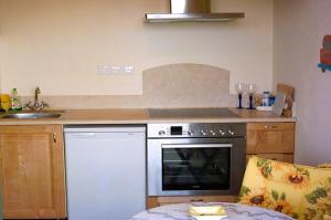 a kitchen with a stove and a counter top at House Lemoni, Apartment B - Pelekas, Corfu in Pelekas +38 photos