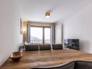 a dining room with a large wooden table and chairs at Appartement La Plagne, 3 pièces, 6 personnes - FR-1-351-93 in La Plagne