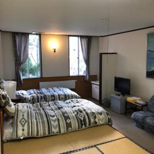Postel nebo postele na pokoji v ubytování Petit Hotel Yukikkoso