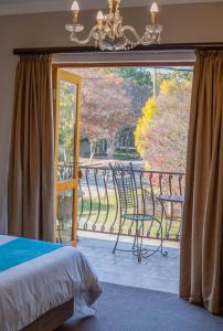 a bedroom with a bed and a balcony with a window at Le Grand Chateau Hotel in Parys