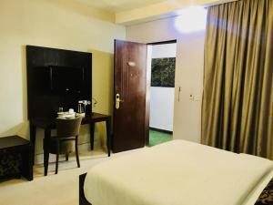 Ένα ή περισσότερα κρεβάτια σε δωμάτιο στο BW Starfire Hotel