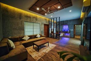 a living room with a couch and a table at Jungle Bay Resorts & Spa in Wayanad