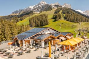 a ski lodge with a mountain in the background at Berglodge Ristis in Engelberg