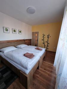 a bedroom with a large bed with two towels on it at Villa-Gallant in Poprad