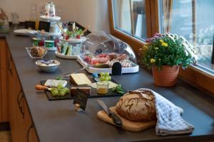 a table with a loaf of bread and vegetables on it at Finkenhof in Schluchsee