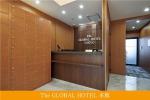 a large room with a large desk and a large mirror at The Global Hotel Tokyo in Tokyo