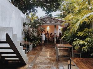 a group of people sitting at a table in a restaurant at Ceylon Sliders in Weligama
