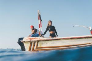 two people on a boat in the water at Ceylon Sliders in Weligama