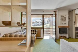 a living room with a couch and a fireplace at Santa Caterina Isola Apartment in Santa Caterina Valfurva