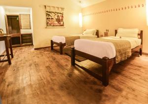 A bed or beds in a room at Machan Country Villa