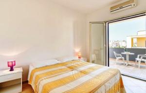 a bedroom with a large bed and a balcony at Residence Ionian Gallipoli in Gallipoli