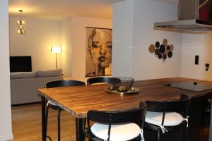 a dining room with a wooden table and chairs at Maison Drappier in Ghent