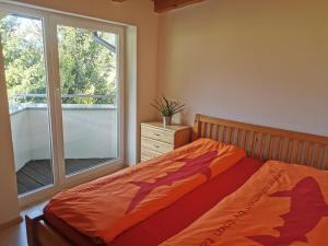 a bedroom with a bed and a large window at Ferienwohnung Christina in Ried im Zillertal