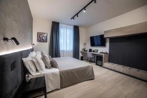 a hotel room with a bed and a television at Corso 84 Luxury Suites in Pescara +77 photos