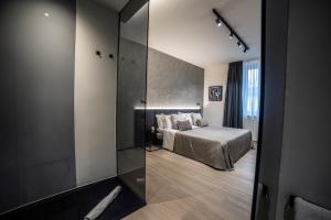 a bedroom with a bed and a glass wall at Corso 84 Luxury Suites in Pescara