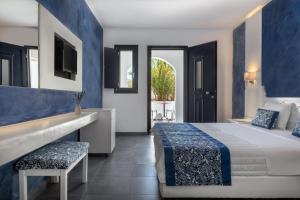A bed or beds in a room at Rivari Santorini Hotel