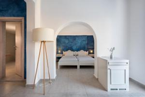 A bed or beds in a room at Rivari Santorini Hotel