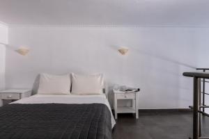 A bed or beds in a room at Rivari Santorini Hotel