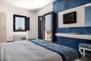 A bed or beds in a room at Rivari Santorini Hotel