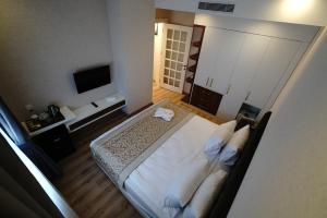 a hotel room with a bed and a television at The Green Park Diyarbakir in Diyarbakır