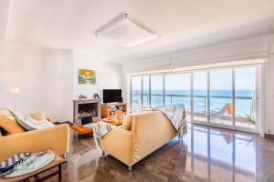 a living room with a view of the ocean at Povoa Sunset Views in Póvoa de Varzim