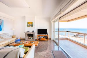 a living room with a view of the ocean at Povoa Sunset Views in Póvoa de Varzim