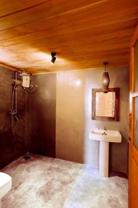 a bathroom with a sink and a mirror at Sea View Clay House in Hiriketiya