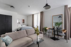 a living room with a couch and a bed at Limehome Linz Friedrichstraße in Linz