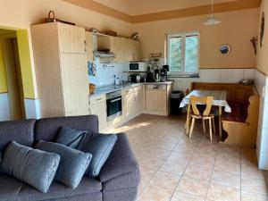 a living room with a couch and a table in a kitchen at Haus Fernblick in Waldkirchen