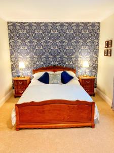a bedroom with a large bed with two night stands at 5 The Croft in Bellingham