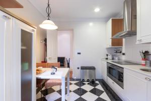 a kitchen with a black and white checkered floor at Bilbao Costa by Aston Rentals in Getxo