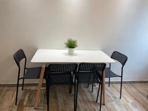 een tafel met stoelen en een potplant erop bij Appartement 13008 bord de mer in Marseille