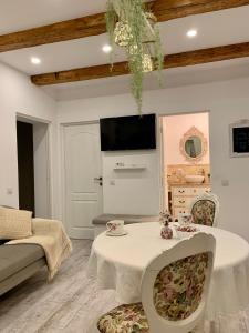 a living room with a white table and chairs at Avram Iancu Apartment in Cluj-Napoca