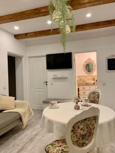 a living room with a white table and chairs at The Hedgehog Boutique House & Garden in Cluj-Napoca
