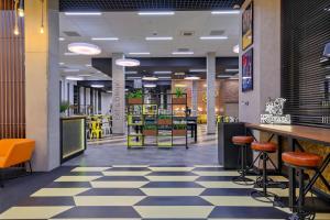 a lobby of a restaurant with a checkered floor at o3Hotel in Warsaw
