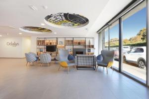 a dining room with chairs and a table in a building at Appart Hotel Odalys City Toulouse Centre Compans Caffarelli in Toulouse