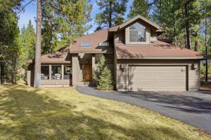 a house with a garage and a driveway at 3 Tumalo with Wood Burning Fireplace in Sunriver