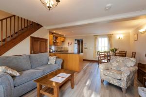 a living room with a couch and a table at Green Acres Cottages in Par