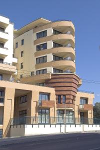 a large apartment building on the side of a street at Tisza Palota Apartmanok in Szeged