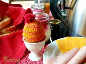 aached egg with a crocheted hat on top of a table at Tshima Bush Camp in Komane