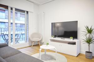 a living room with a large flat screen tv at Izpizua Apartment in San Sebastián