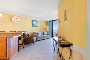 a living room with a couch and a table at 1BR Ocean Forest Plaza Condo w Breathtaking Views in Myrtle Beach