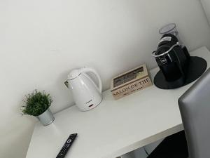a counter with a coffee maker and a blender on it at Tiburtina Royal Suites in Rome